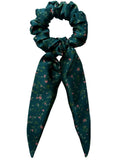Emerald Posy classic silk scarf scrunchie with detachable tails, flat lay showing coral flowers and leaves on emerald green