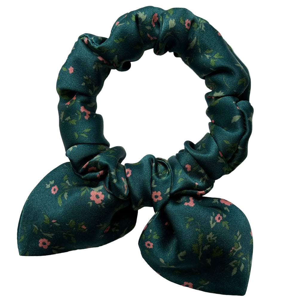 Emerald Posy mini silk bow scrunchie with a detachable bow, flat lay showing tiny coral flowers and leaves on deep emerald green