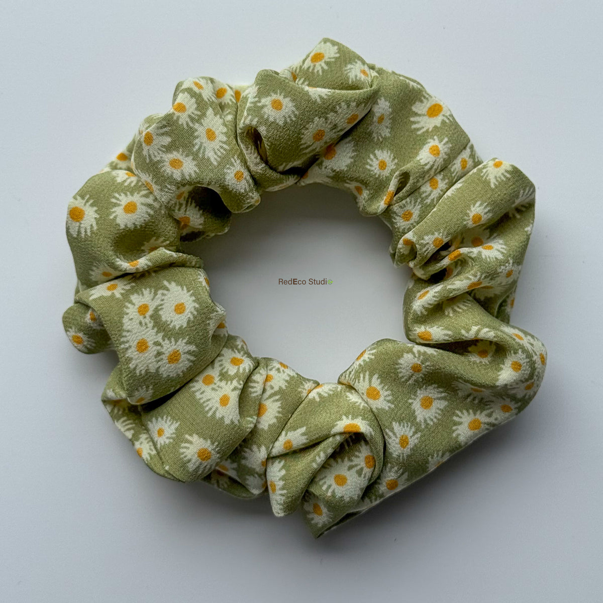 Matcha Daisy classic silk scrunchie with the tails removed, flat lay showing the green daisy print