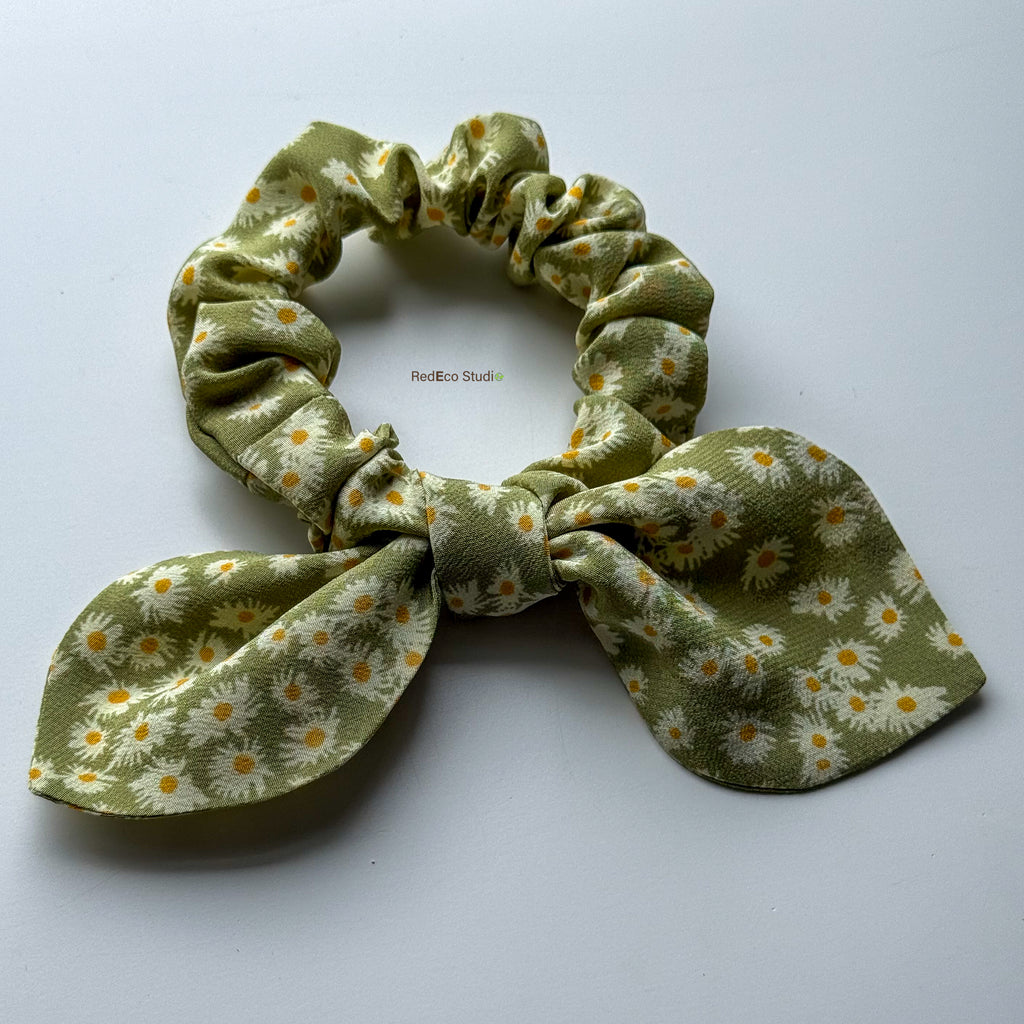 Matcha Daisy mini silk crêpe de chine scrunchie with a detachable bow, angled view