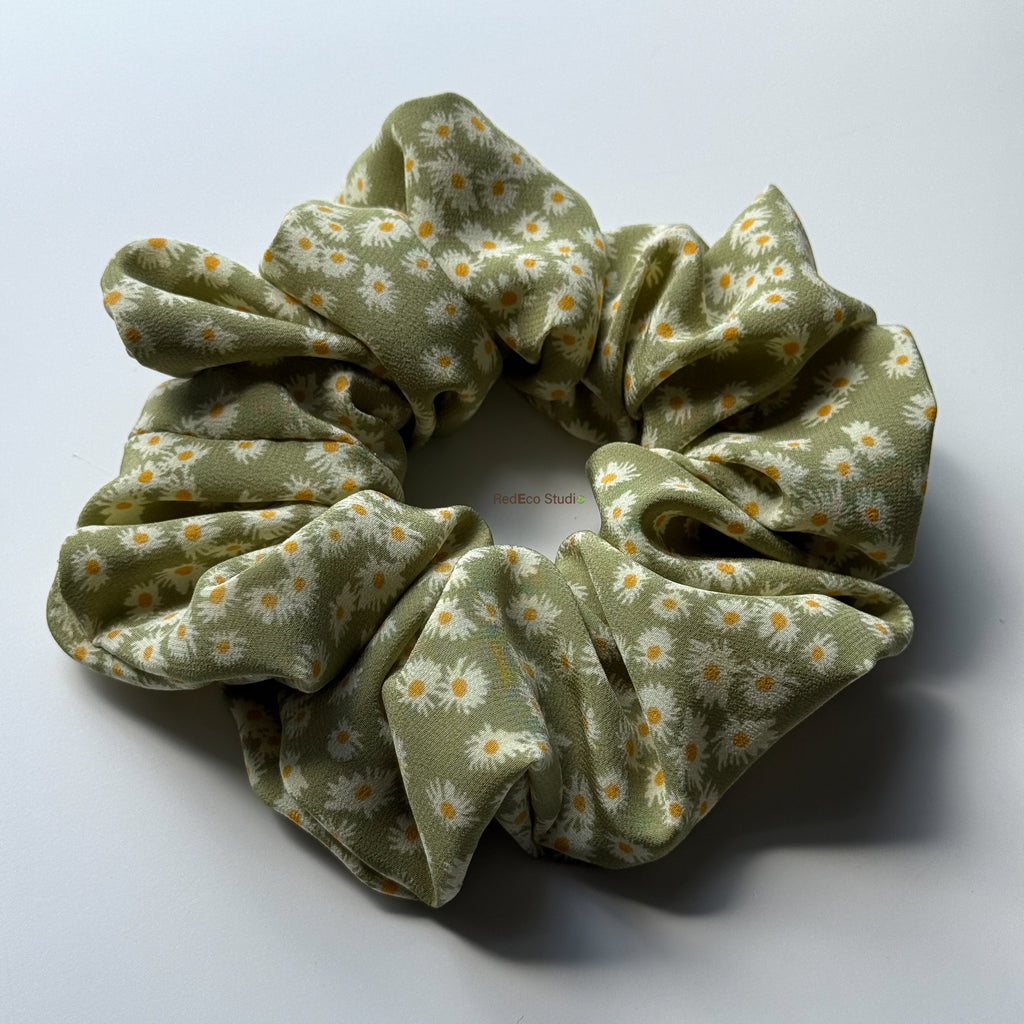 Matcha Daisy oversized pure silk scrunchie in a sage green daisy print, angled view of its full gathers