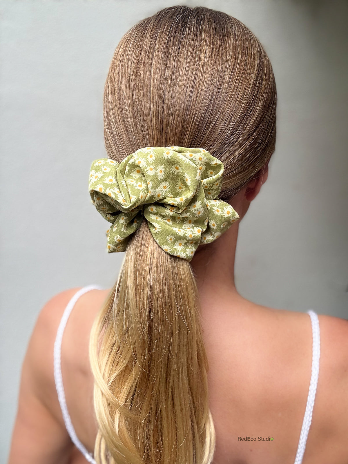 Matcha Daisy oversized silk scrunchie worn on a low ponytail, back view, sage green crêpe de chine with cream and yellow daisies
