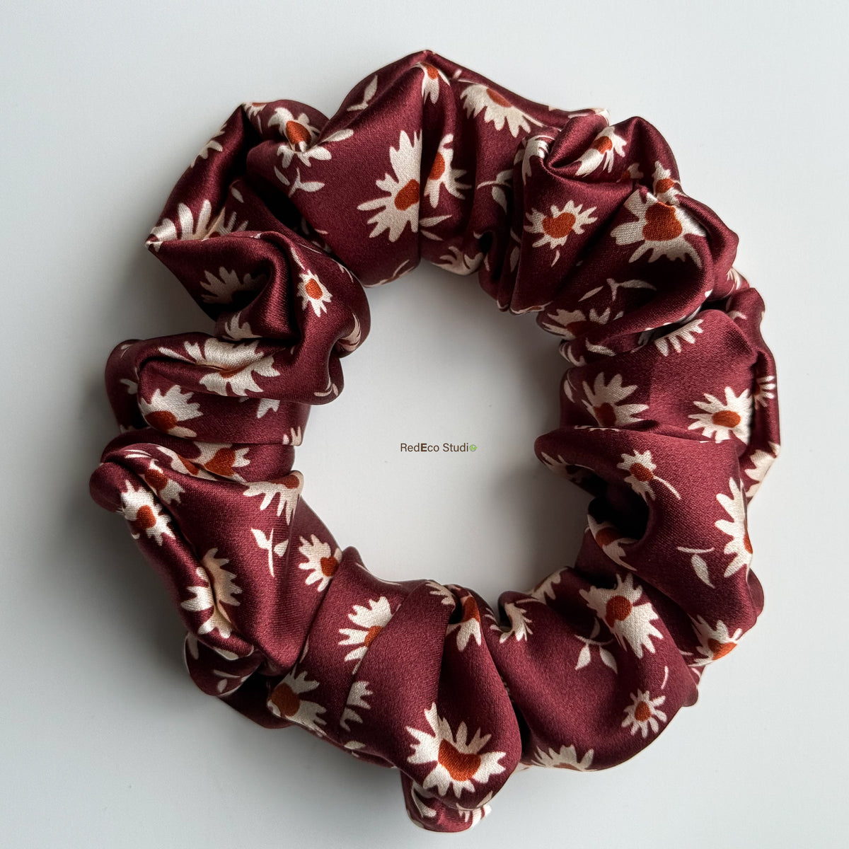 Merlot Daisy classic silk scrunchie with the tails removed, flat lay showing the burgundy daisy print in 19 momme silk satin