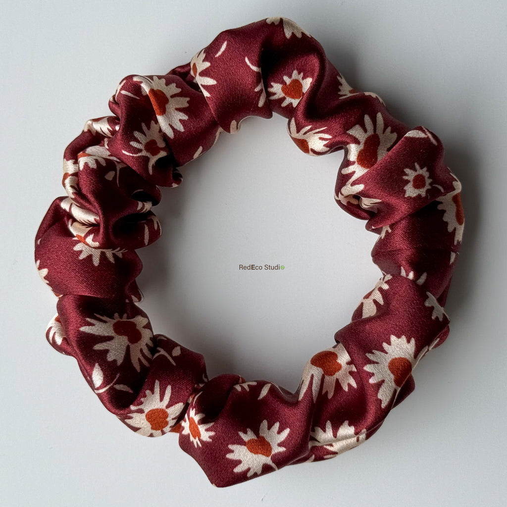 Merlot Daisy mini silk scrunchie with the bow tails removed, flat lay showing the burgundy daisy print in 19 momme silk satin