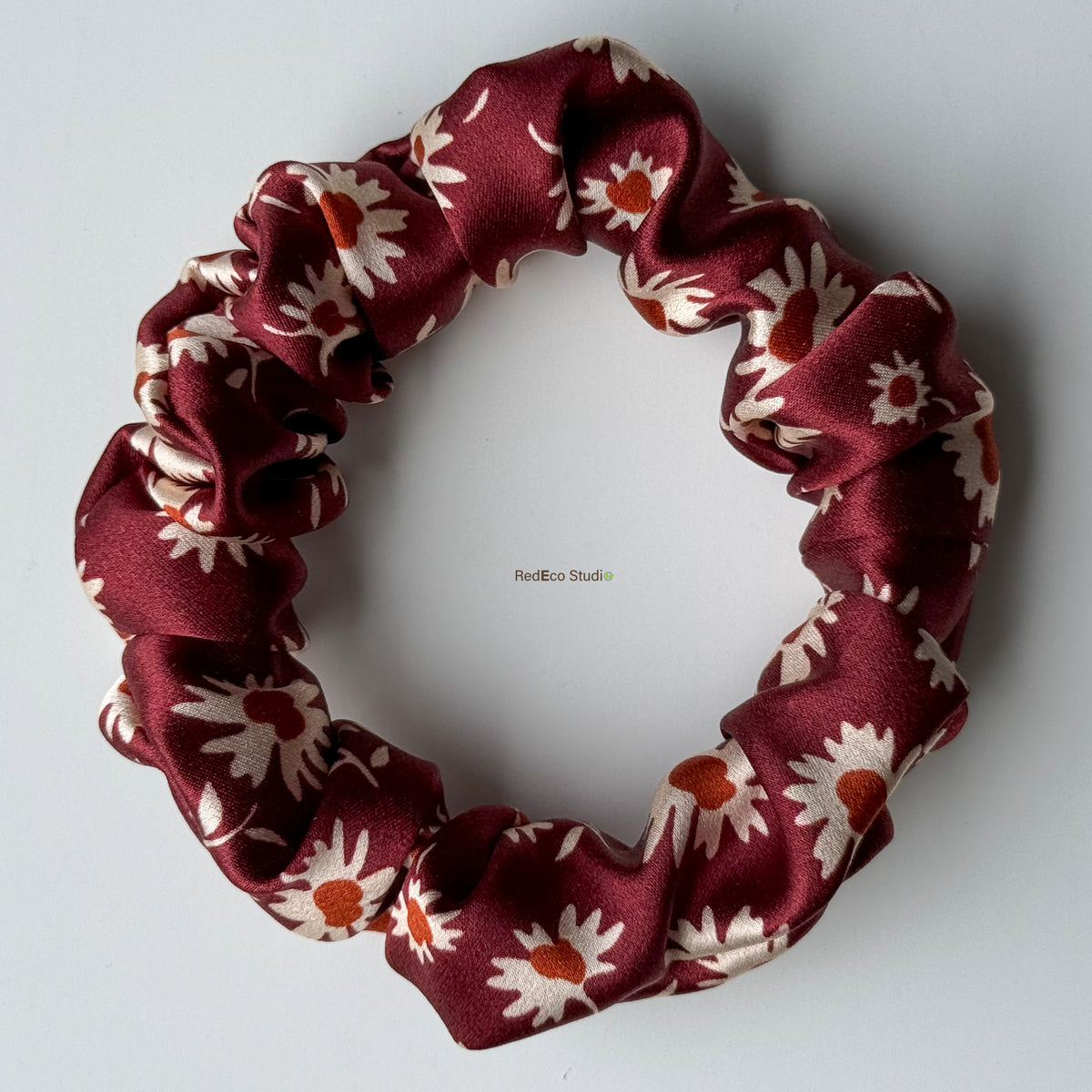Merlot Daisy mini silk scrunchie with the bow tails removed, flat lay showing the burgundy daisy print in 19 momme silk satin