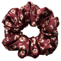 Merlot Daisy oversized silk satin scrunchie, flat lay top view showing cream daisies with rust-orange centres on burgundy