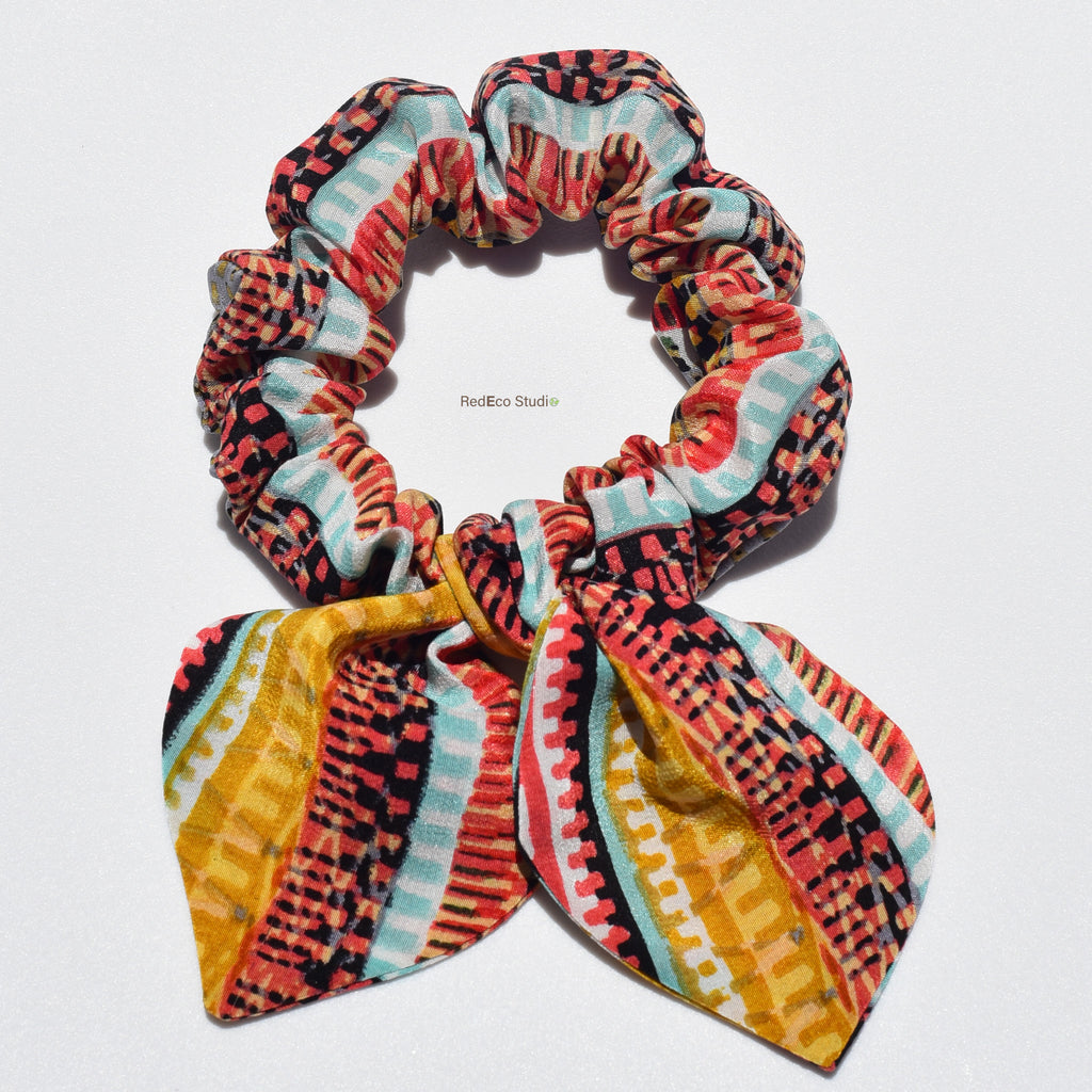 Colorful patterned silk scrunchie on a white background