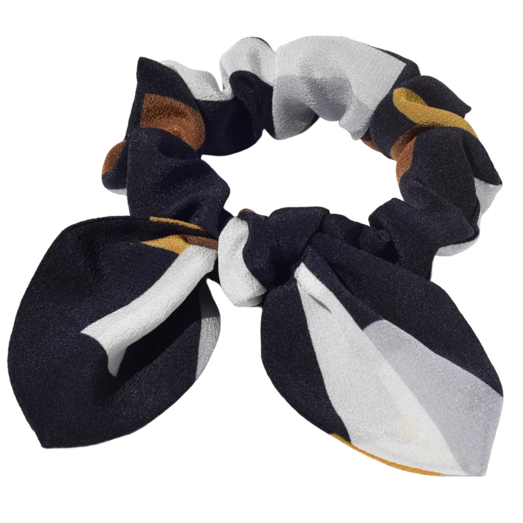 Patterned silk hair scrunchies with a bow on a light gray background