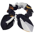 Patterned silk hair scrunchies with a bow on a light gray background