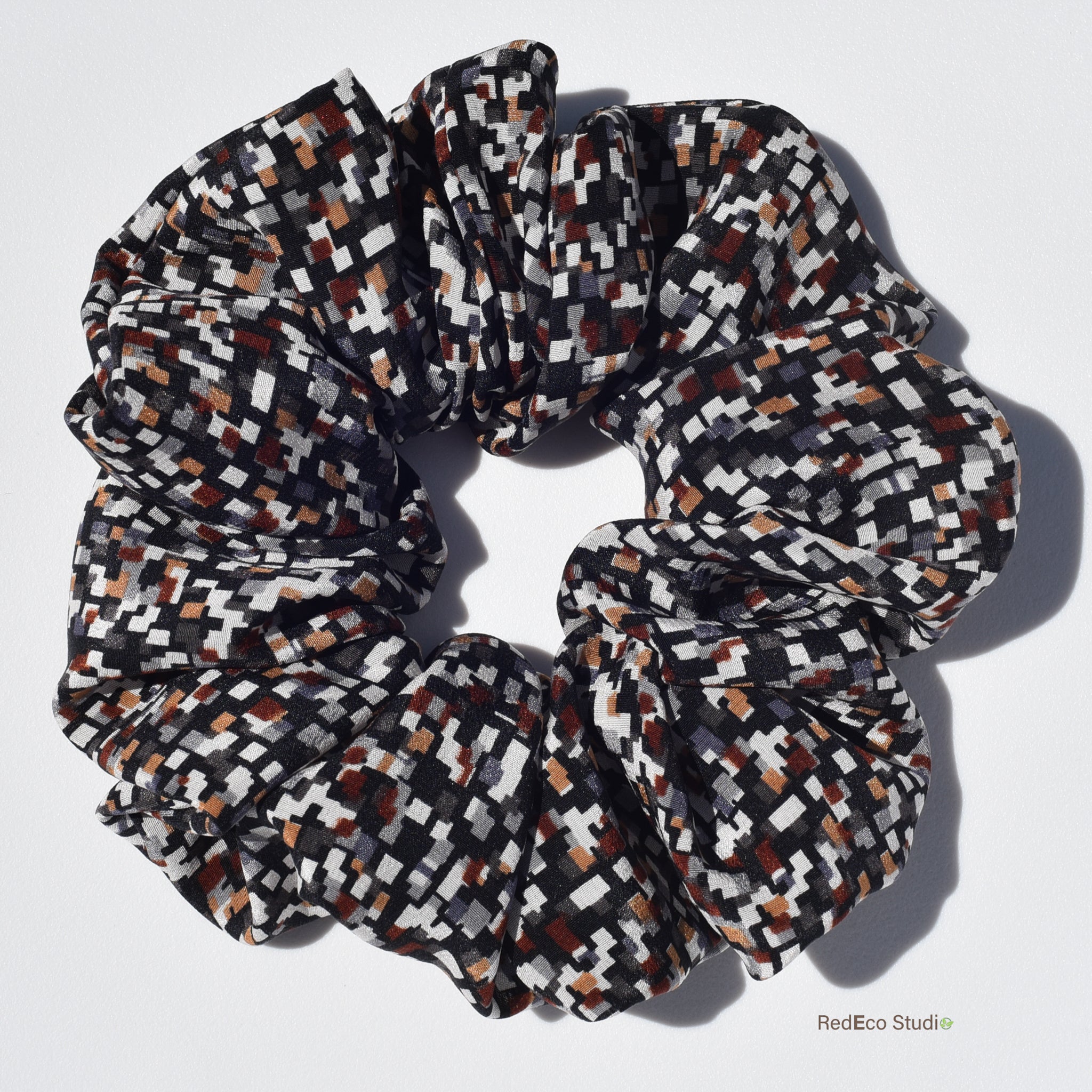Large patterned silk scrunchie on a white background