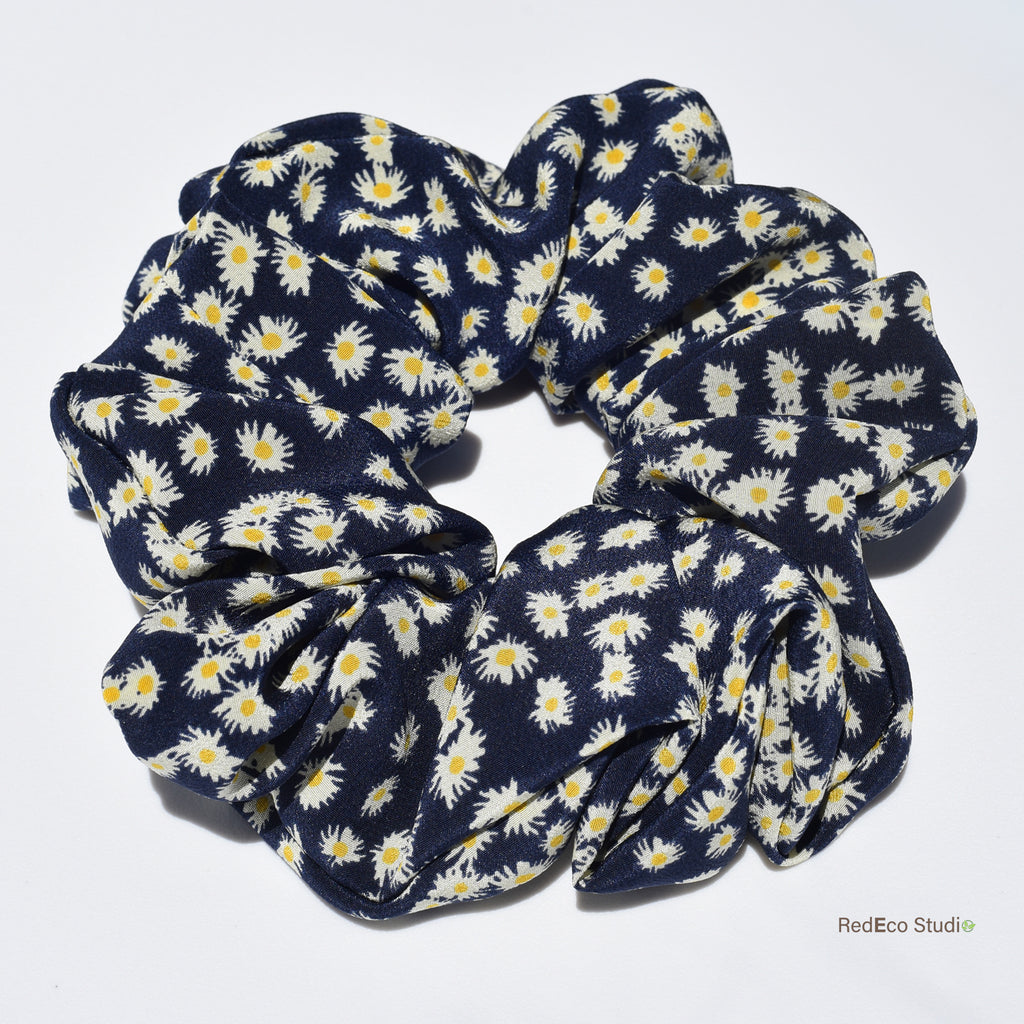 Large navy blue silk scrunchie with white floral pattern on a white background