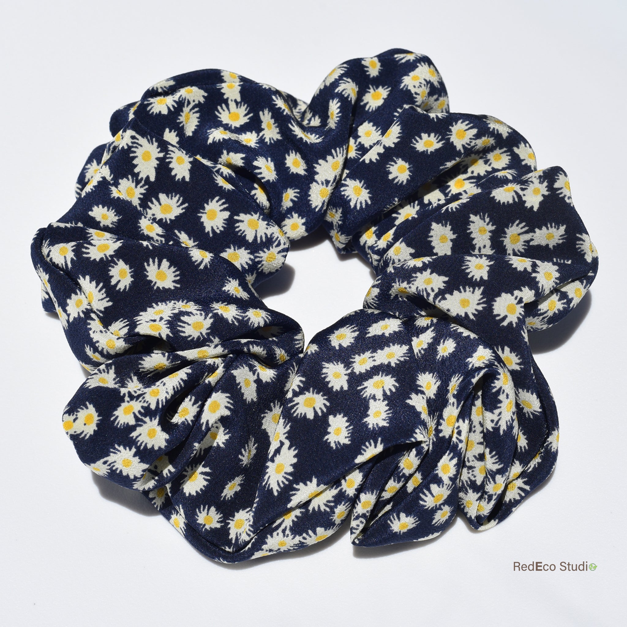 Large navy blue silk scrunchie with white floral pattern on a white background