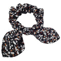 Patterned silk scrunchie with bow on a white background
