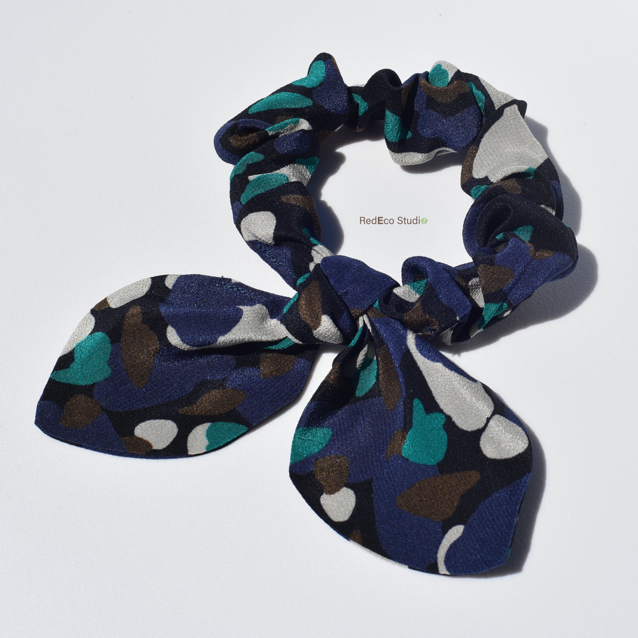 Mini 100% Silk Bow Scrunchie - Multicolour abstract pattern on a navy blue base