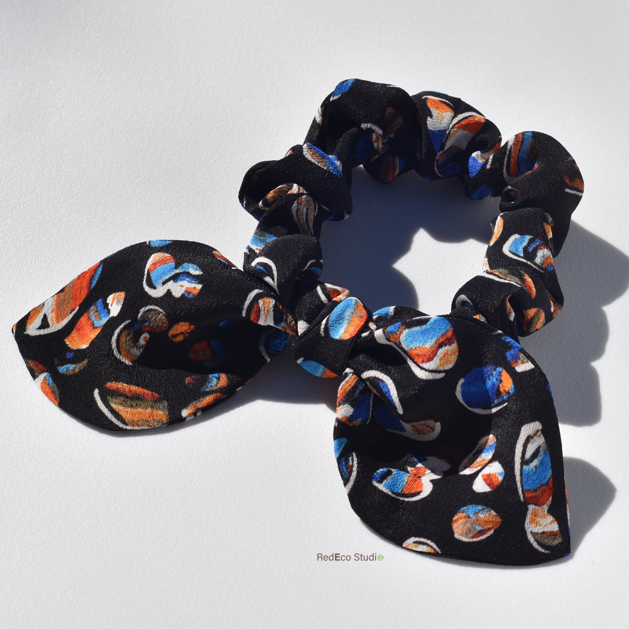 Mini 100% Silk Bow Scrunchie - Pebbles on a navy blue base