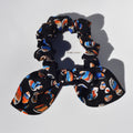 Silk scrunchie with colorful pattern on a white background