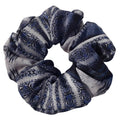 Blue and gray patterned scrunchie on a white background