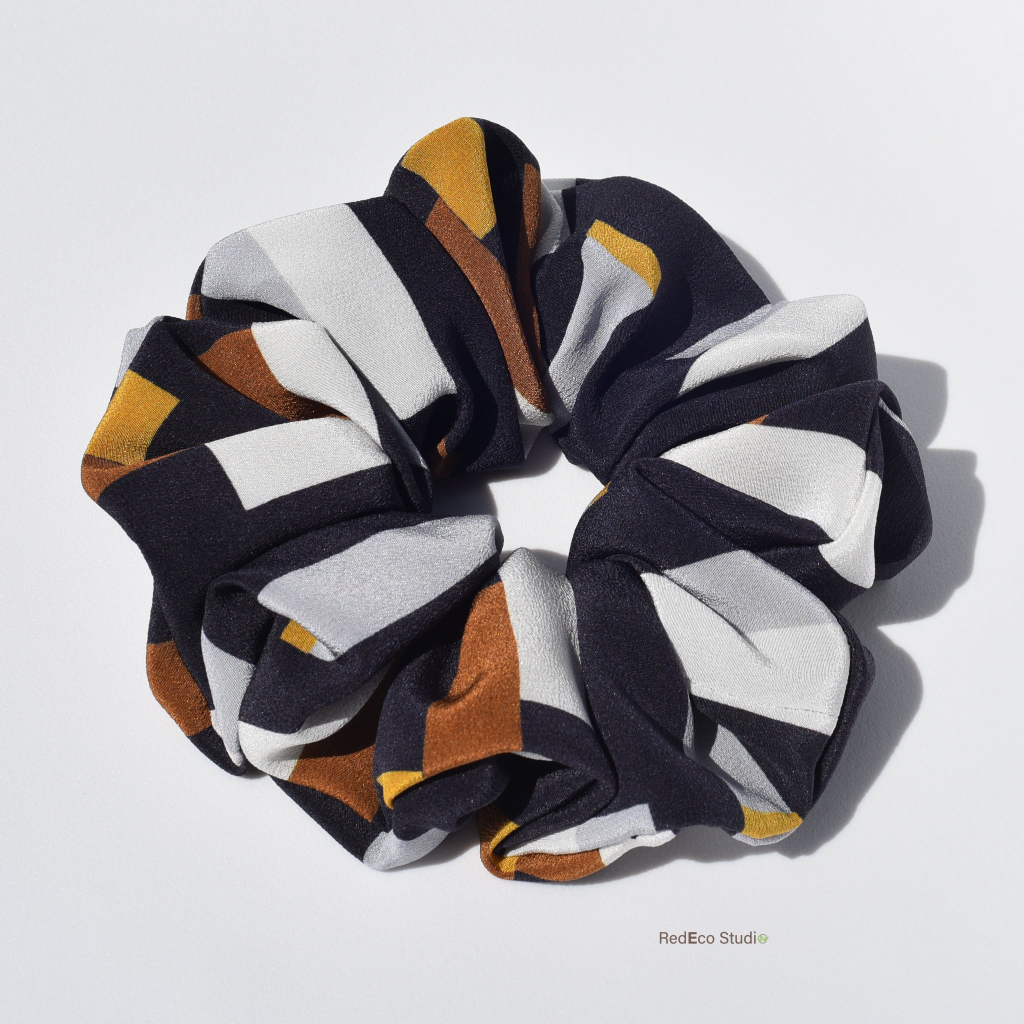 Multicolored silk scrunchie on a white background