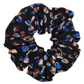 Black scrunchie with colorful dog pattern on a white background