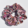 Large floral patterned silk scrunchie on a white background