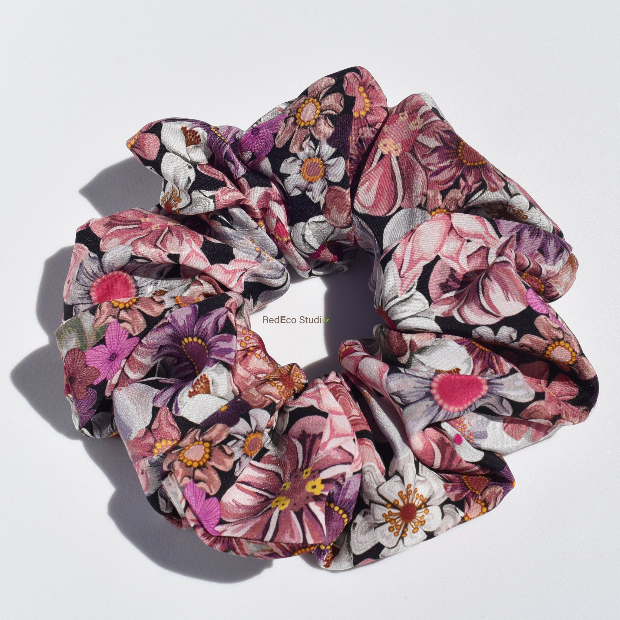 Large floral patterned silk scrunchie on a white background