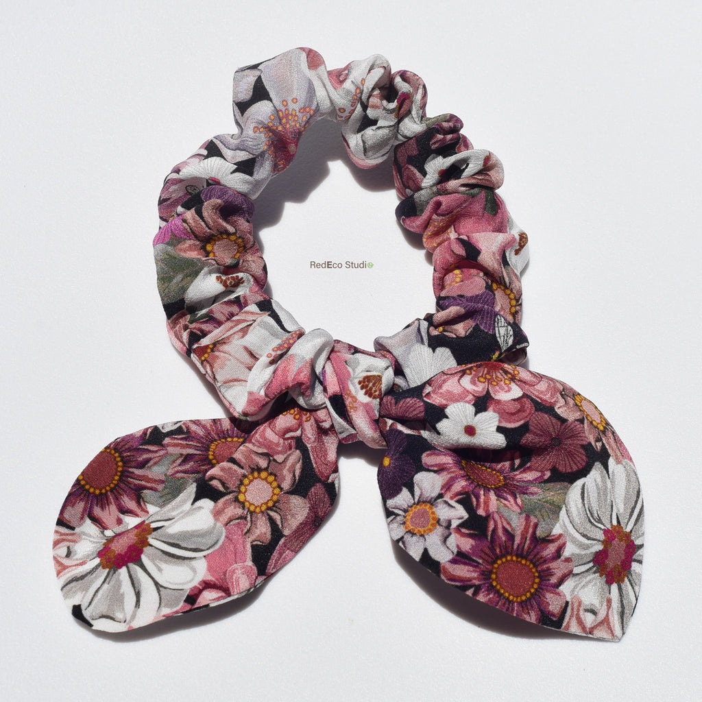Floral patterned silk scrunchie on a white background