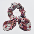 Floral patterned silk scrunchie on a white background