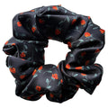 Rosebud Noir oversized silk satin scrunchie, flat lay top view showing the red rosebud print on black