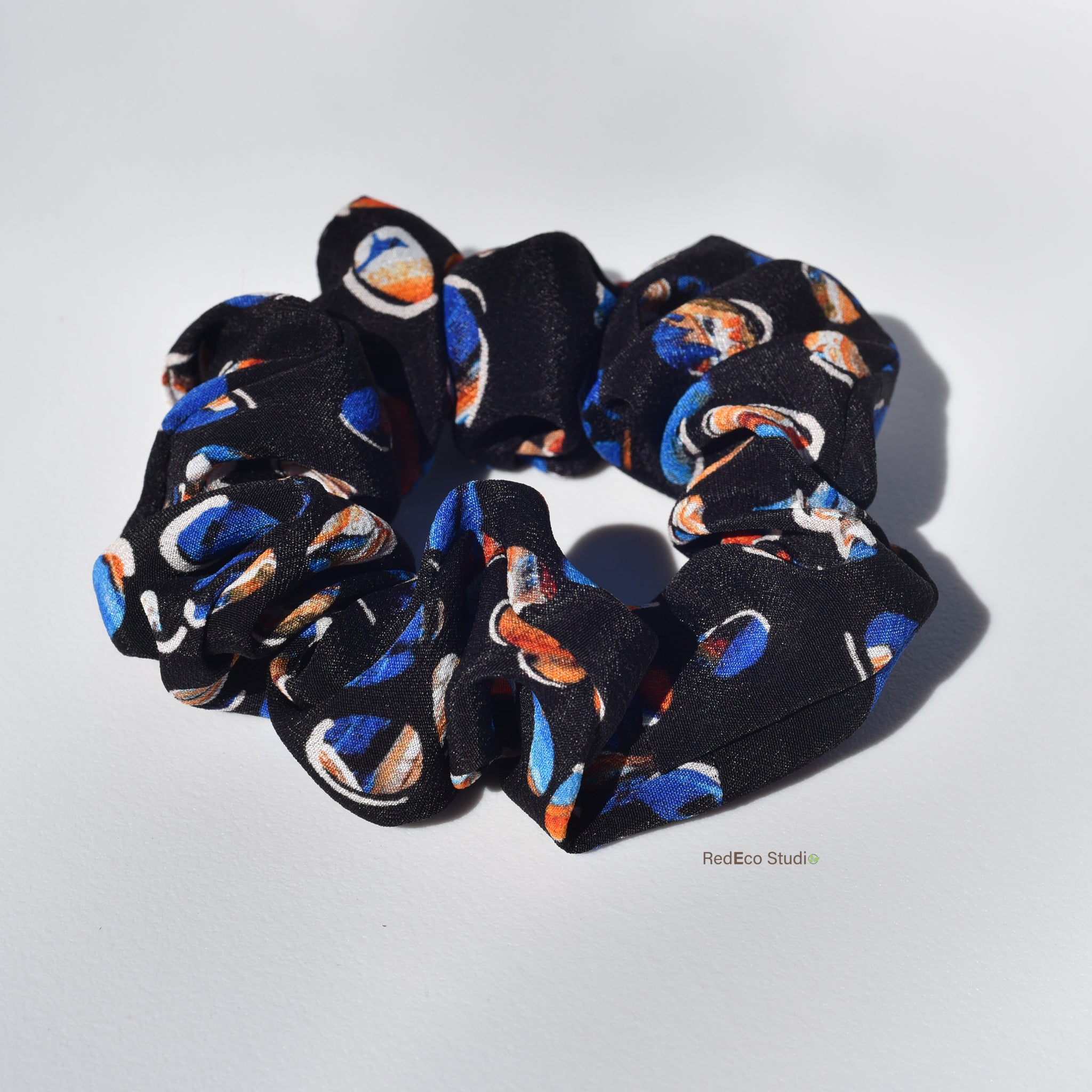 silk scrunchie with colorful pattern on a white background